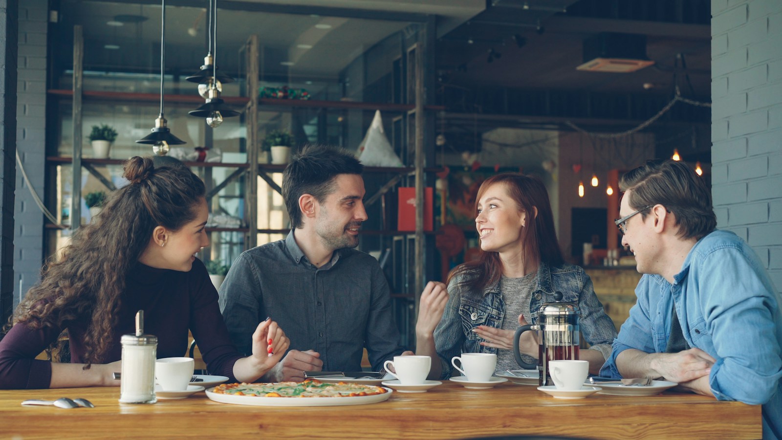 Friends sharing coffee and conversation at a café